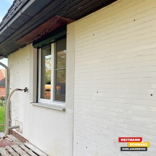 a white house with a wood deck and a window